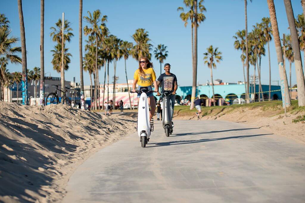 People enjoying the OjO Scooter